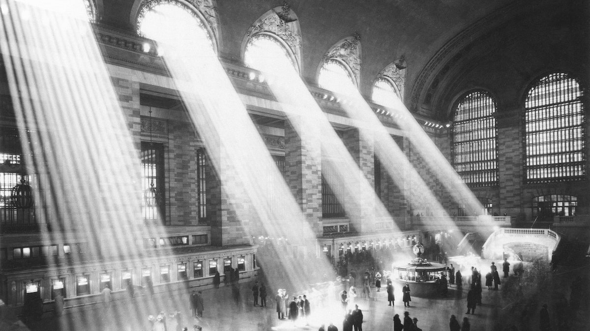 black and white image of light refracting through windows in New York's Grand Central Terminal 