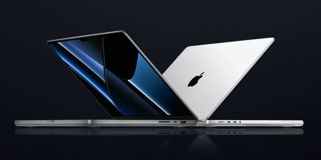 two laptops facing away from each other on a black background