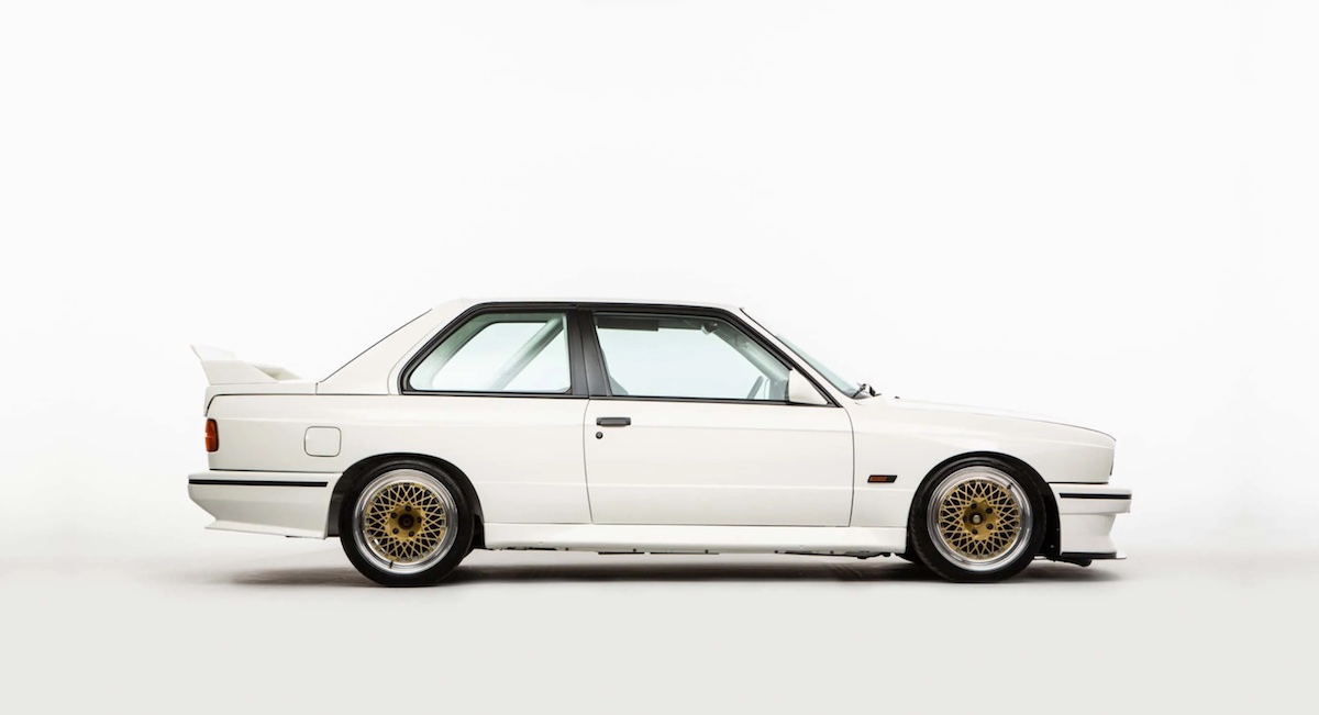 White BMW with gold rims on a white background